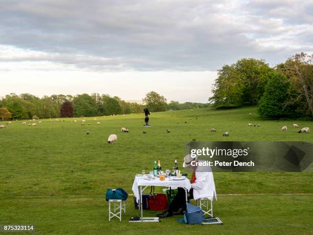 Picnic on the lawn at Glyndebourne during the interval at the opera. Glyndebourne is an English country house, the site of an opera house that, since...