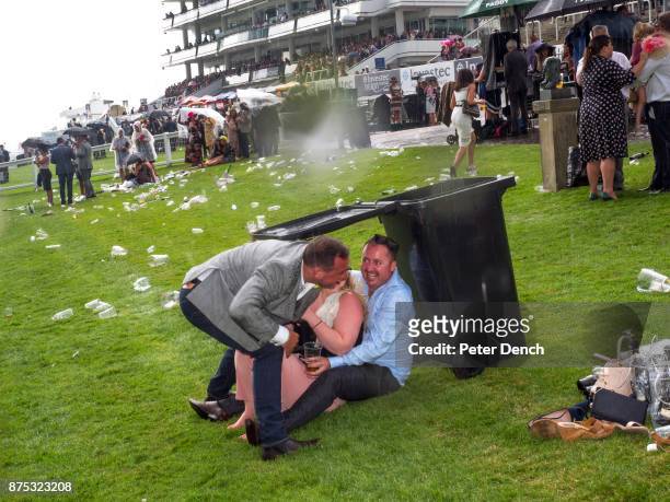 Visitor to Epsom take evasive action during a downpour. Ladies' Day is traditionally held on the first Friday of June, a multitude of ladies and...