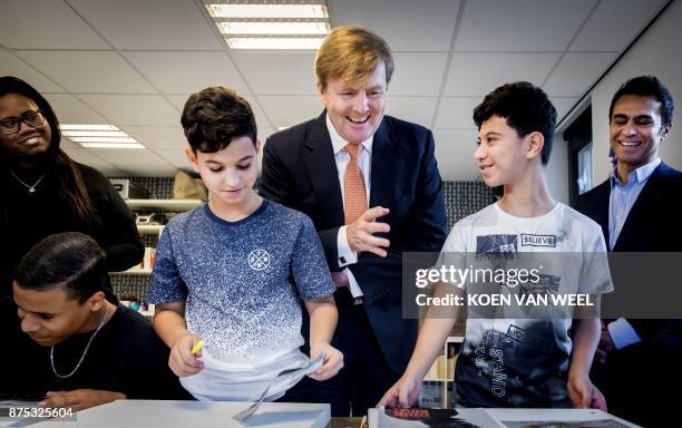 Netherlands' King Willem-Alexander visits the 'Weekend Academie' on November 17, 2017 in Amsterdam. Weekend Academie is a youth support centre that...