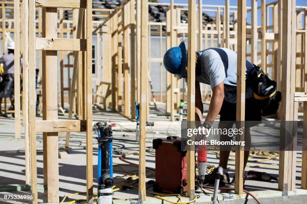 Contractor works on the frame of a home under construction at the D.R. Horton Express Homes Magma Ranch housing development in Florence, Arizona,...