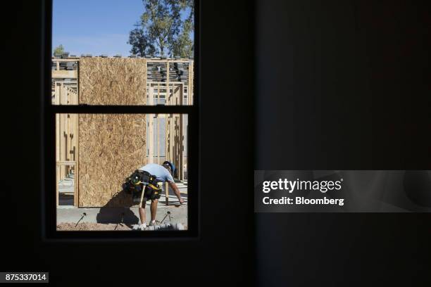 Contractor works on the frame of a home under construction at the D.R. Horton Express Homes Magma Ranch housing development in Florence, Arizona,...