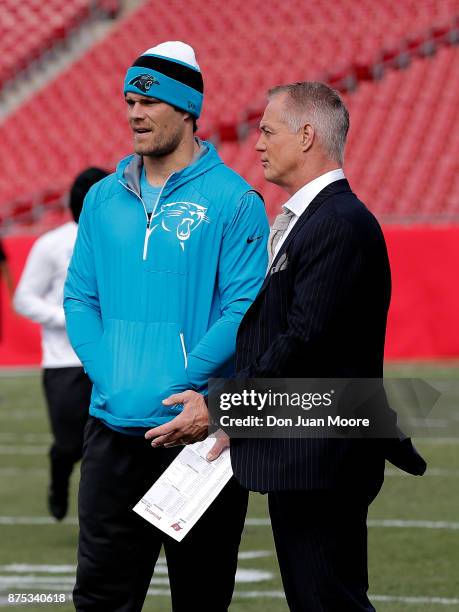 Tight End Greg Olsen of the Carolina Panthers talk with Fox NFL Analyst Daryl Johnson on the field before the game against the Tampa Bay Buccaneers...