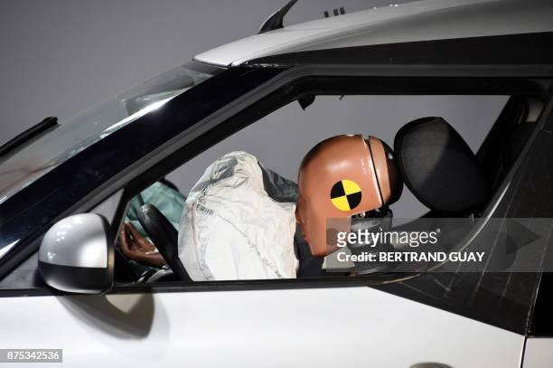 Car and its airbag are pictured after a frontal crash test with another car, without a safety belt buckled in the back seat, as part of France's Road...