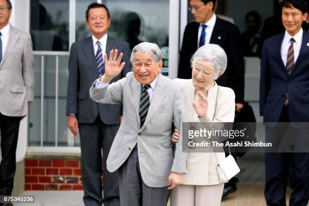 Emperor Akihito and Empress Michiko wave to well-wishers on arrival at Yoron airport during their visit to Yoronjima Island on November 17, 2017 in...