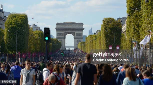 Tourists and Parisians enjoy the Champs Elysées during the 2016 car-free day organised in Paris across 45% of the area of the city on September 25,...