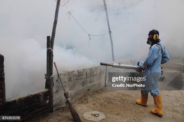 Health worker fumigation densely populated areas to prevent the spread of Aedes aegypti, in an attempt to control dengue fever at a neighborhood in...