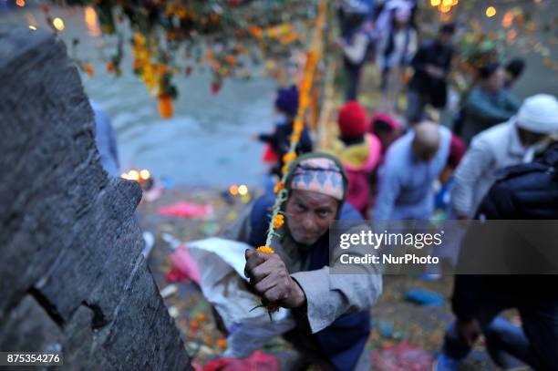 Nepalese devotees tighten religious rope consists of flower, fruits and holy grains at the Pashupatinath Temple on the occasion of Bala Chaturdashi...