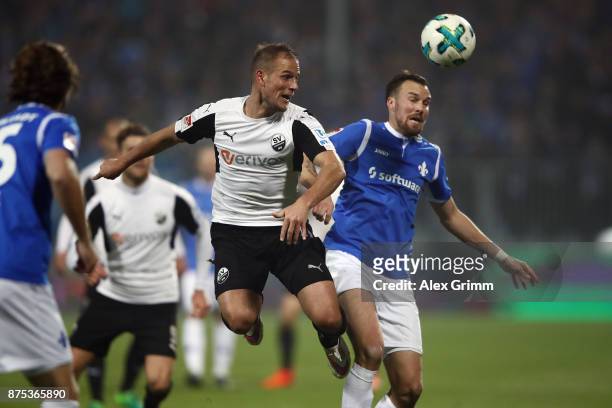 Manuel Stiefler of Sandhausen is challenged by Kevin Grosskreutz of Darmstadt during the Second Bundesliga match between SV Darmstadt 98 and SV...
