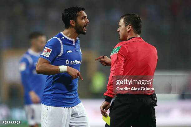 Team captain Aytac Sulu of Darmstadt disusses with referee Christian Dietz during the Second Bundesliga match between SV Darmstadt 98 and SV...