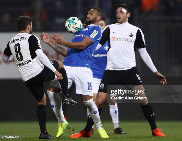 Terrence Boyd of Darmstadt is challenged by Nejmeddin Daghfous and Tim Kister of Sandhausen during the Second Bundesliga match between SV Darmstadt...