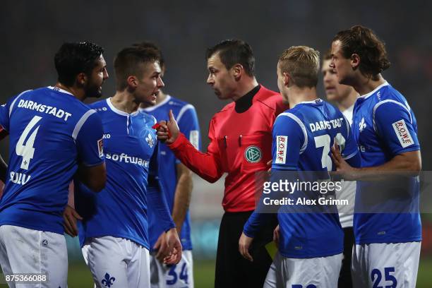 Players of Darmstadt discuss with referee Christian Dietz during the Second Bundesliga match between SV Darmstadt 98 and SV Sandhausen at...