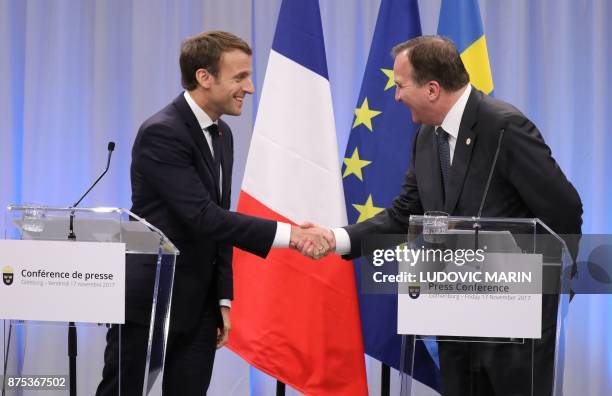 France's President Emmanuel Macron and Sweden's Prime Minister Stefan Lofven shake hands after a press conference during a visit to the Volvo Campus...