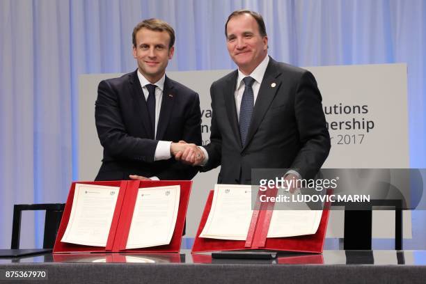 France's President Emmanuel Macron and Sweden's Prime Minister Stefan Lofven shake hands after signing a treaty of Innovation & Green Solutions a...