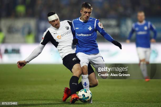 Marvin Mehlem of Darmstadt is challenged by Tim Kister of Sandhausenduring the Second Bundesliga match between SV Darmstadt 98 and SV Sandhausen at...