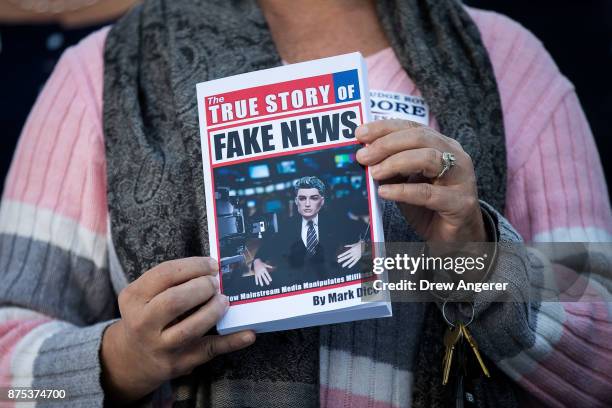 Woman holds a book during a 'Women For Moore' rally in support of Republican candidate for U.S. Senate Judge Roy Moore, in front of the Alabama State...