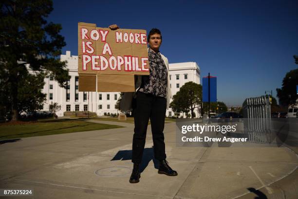 Rose Falvey protests across the street from a 'Women For Moore' rally in support of Republican candidate for U.S. Senate Judge Roy Moore, in front of...