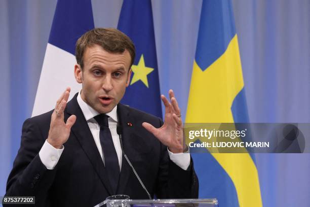 France's President Emmanuel Macron addresses a press conference a press conference during a visit to the Volvo Campus Lundby of the Swedish carmaker...