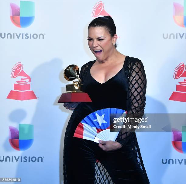 Olga Tanon poses with the award for Best Tropical Fusion Album in the press room during The 18th Annual Latin Grammy Awards at MGM Grand Garden Arena...