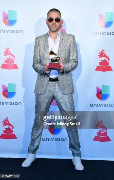 Rafael Arcaute poses with the award for Best Urban Song in the press room during The 18th Annual Latin Grammy Awards at MGM Grand Garden Arena on...