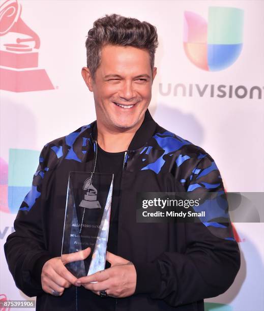 Honoree Alejandro Sanz poses with the award for Person of the Year in the press room during The 18th Annual Latin Grammy Awards at MGM Grand Garden...