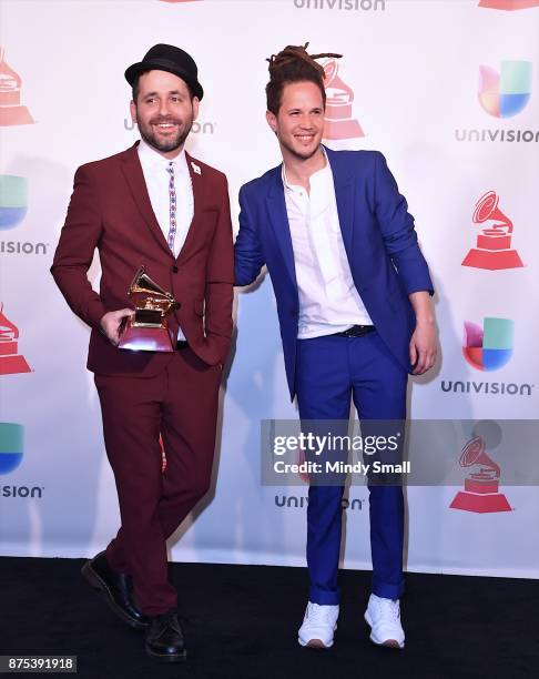 Eduardo Cabra and Vicente Garcia pose with the award for Producer of the Year in the press room during The 18th Annual Latin Grammy Awards at MGM...