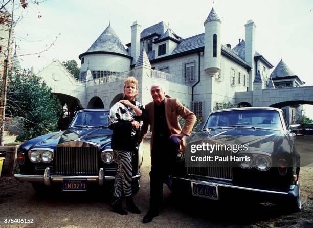 Marvin Mitchelson and his wife, Marcella, pose in front of two Rolls Royce cars and their palatial home on January 1, 1989 in West Hollywood,...