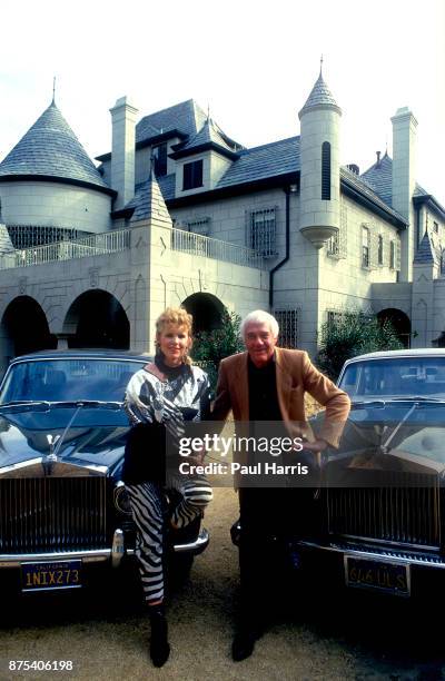 Marvin Mitchelson and his wife, Marcella, pose in front of two Rolls Royce cars and their palatial home on January 1, 1989 in West Hollywood,...