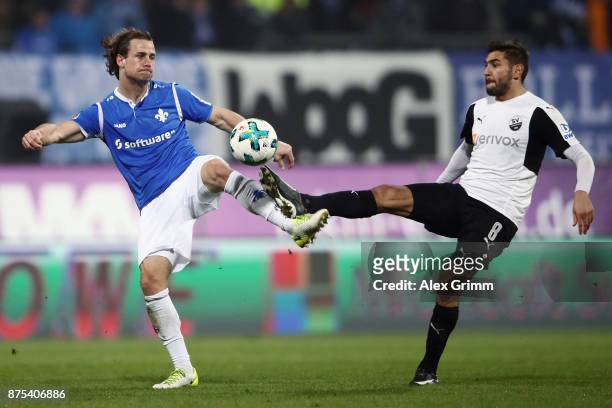 Yannick Stark of Darmstadt is challenged by Nejmeddin Daghfous of Sandhausen during the Second Bundesliga match between SV Darmstadt 98 and SV...