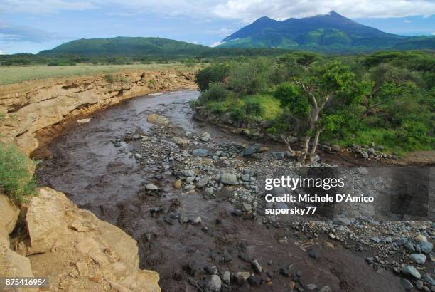 dark termporary stream swollen by strong rainfall - mount meru stock pictures, royalty-free photos & images