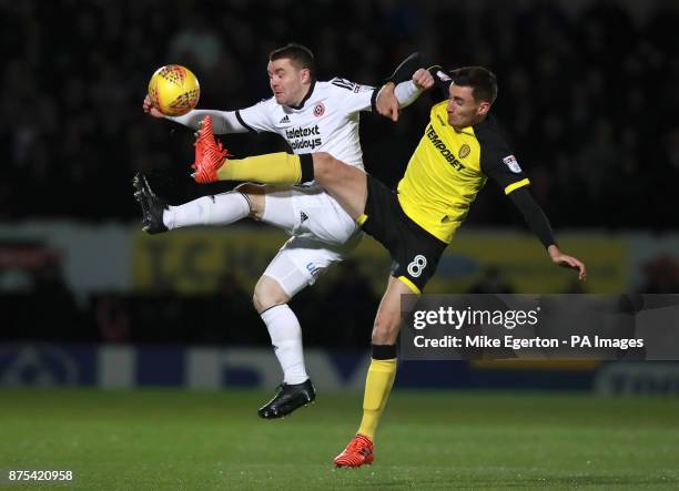 Sheffield United's John Fleck and Burton Albion's Matthew Lund during the Sky Bet Championship match at The Pirelli Stadium, Burton.