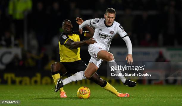 Lucas Akins of Burton tackles Paul Coutts of Sheffield Utd during the Sky Bet Championship match between Burton Albion and Sheffield United at...