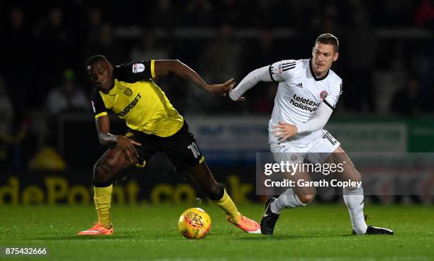 Lucas Akins of Burton tackles Paul Coutts of Sheffield Utd during the Sky Bet Championship match between Burton Albion and Sheffield United at...