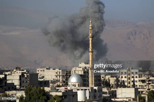 Smoke rises after Assad regime's warcrafts carry out intensifying airstrikes over residential areas of Arbin town of the Eastern Ghouta region of...