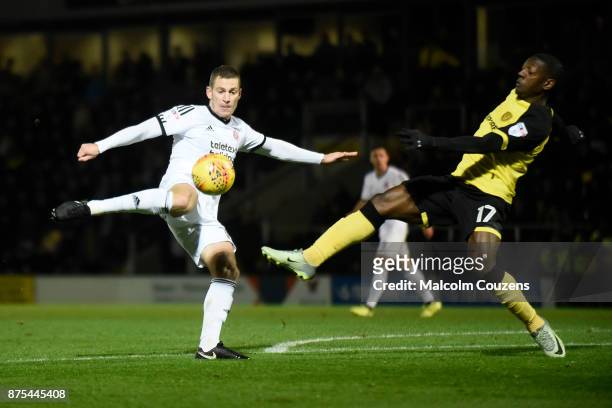 Paul Coutts of Sheffield United shots at goal under pressure from Marvin Sordell of Burton Albion and is injured during the Sky Bet Championship...