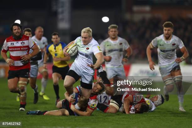 Vincent Koch of Saracens on the charge as Billy Twelvetrees of Gloucester holds on in the tackle during the Aviva Premiership match between...
