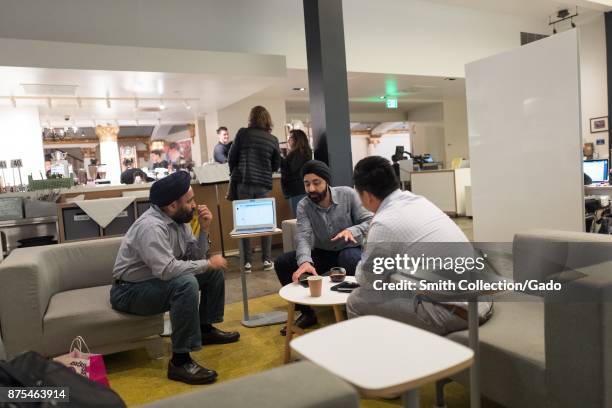 Three men wearing turbans conduct a meeting at SAP HanaHaus co-working space at the Blue Bottle Coffee shop in Silicon Valley, Palo Alto, California,...