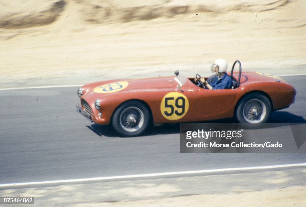 View of Mr. Pierre Mion behind the wheel of his 1957 AC Ace-Bristol Roadster No. 59 convertible sports car, driving at speed during the SCCA National...