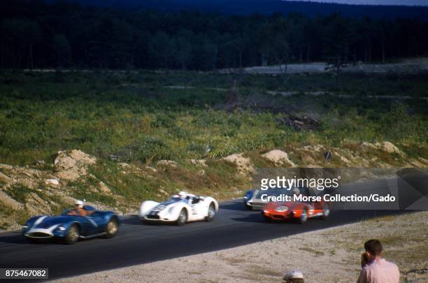 Action view of sports cars driving at speed during the SCCA National Races in Montgomery, New York, August 17, 1958. At left edge is Chuck Daigh...