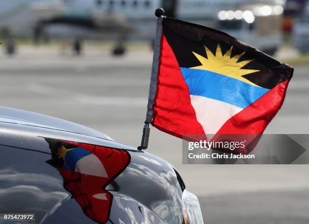 Flag flies from the front of the Royal Car as Prince Charles, Prince of Wales arrives on a British Airways flight into VC Bird International Airport...