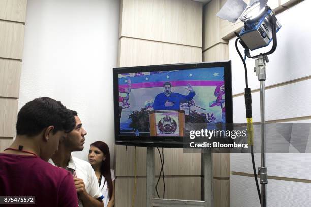 Television displays a speech by Nicolas Maduro, Venezuela's president, before a news conference with Tareck El Aissami, Venezuela's vice president,...