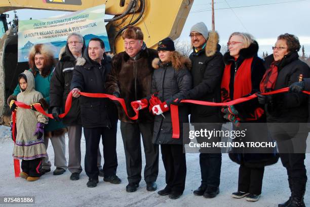 Officials are seen after the ribbon cutting near Muskrat Road on November 15 shown Darrel Nasogaluak and his daughter Sabrina, Louis Sebert , Wally...