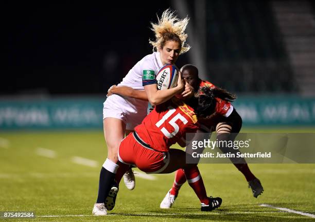 Abigail Dow of England is tacked by Anais Holly of Canada during the Old Mutual Wealth Series between England Women and Canada Women at Allianz Park...