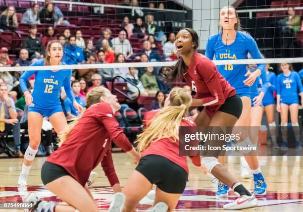 Stanford middle blocker Tami Alade watches the ball fly to back court after a successful dig by Stanford outside hitter Kathryn Plummer and Stanford...