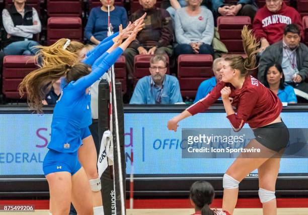 Outside hitter Reily Buechler and UCLA setter Kylie Miller get a block on Stanford opposite Merete Lutz during the regular match between the UCLA...