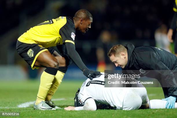 Marvin Sordell of Burton Albion shows concern for Paul Coutts of Sheffield United following a collision which broke Coutts's leg during the Sky Bet...