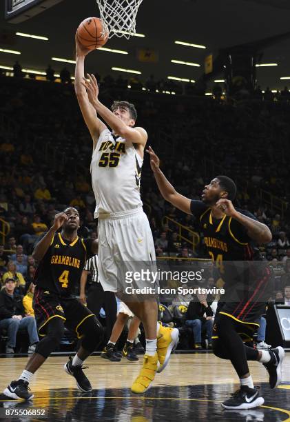 Iowa forward Luka Garza puts up a shot over Grambling State guard Dionte Jones in the second half during a non-conference college basketball game...