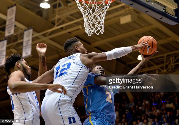 Javin DeLaurier of the Duke Blue Devils blocks a shot by Emanual Shepherd of the Southern University Jaguars during their game at Cameron Indoor...