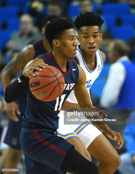 Jaylen Hands of the UCLA Bruins guards Janai Raynor Powell of the South Carolina State Bulldogs as he drives to the basket in the first half of the...