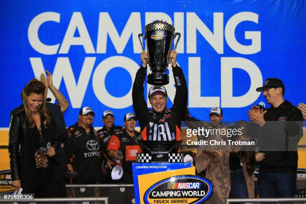 Christopher Bell, driver of the JBL Toyota, celebrates with the trophy in Victory Lane after placing second and winning the Camping World Truck...