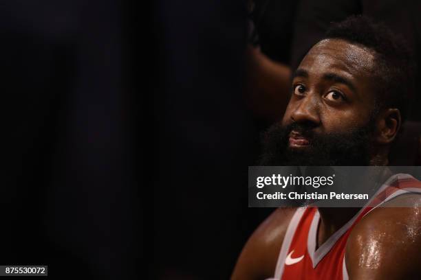 James Harden of the Houston Rockets sits on the bench during the first half of the NBA game against the Phoenix Suns at Talking Stick Resort Arena on...